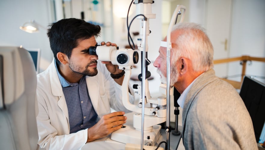 Older man having his retinas examined by doctor